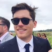 Man in sunglasses at an outdoor event.