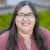Smiling woman with glasses outdoors