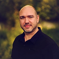 Bald man with beard in outdoor portrait